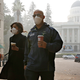 Two people don masks to deal with the smoke from the Camp Fire that shrouds the state Capitol in Sacramento, California.